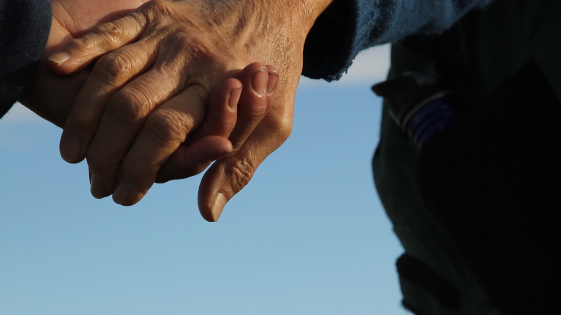 people holding hands in prayer at the Standing Rock Reservation