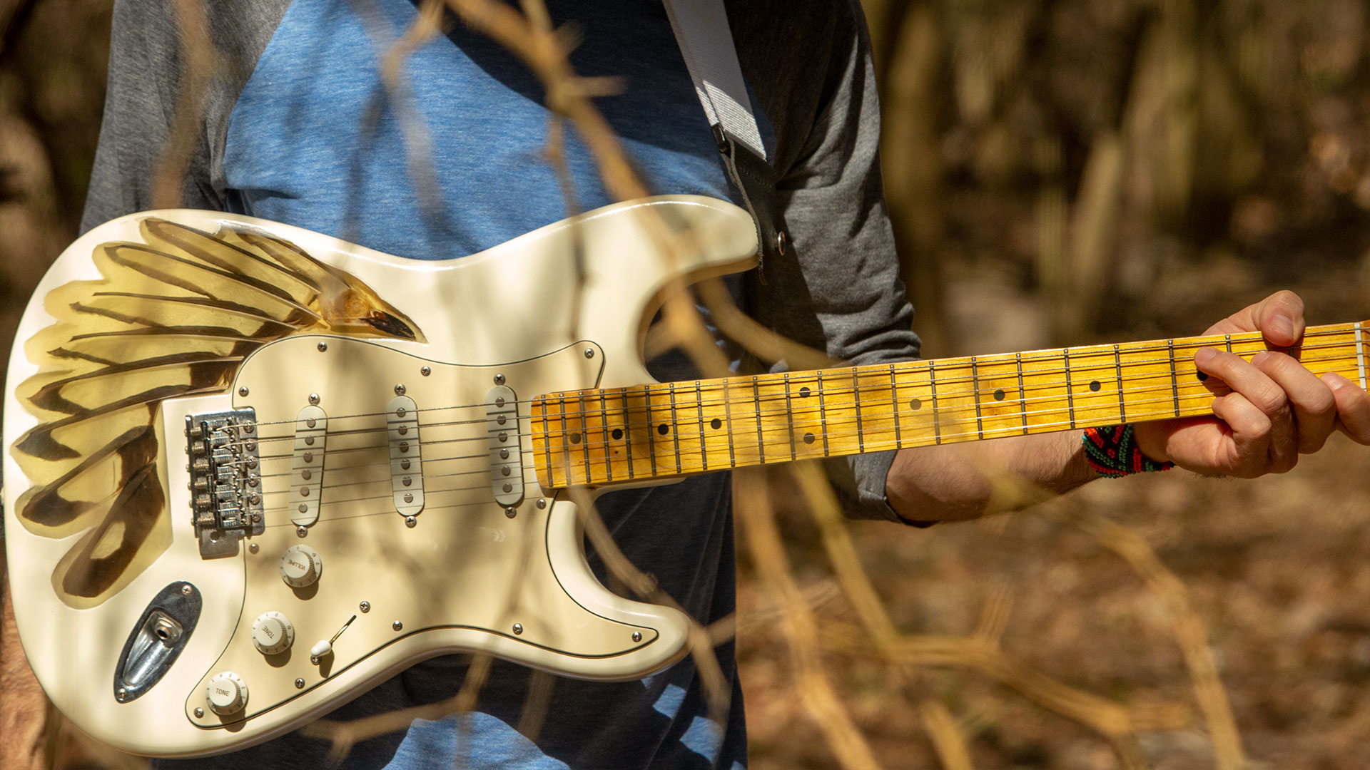 white electric guitar in trees