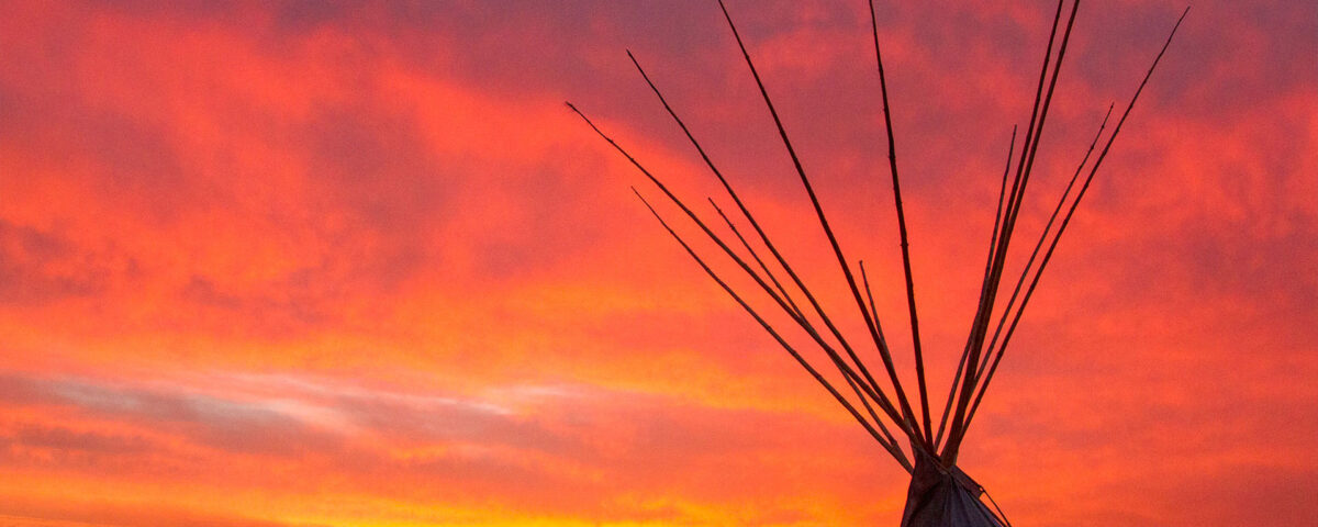 sunrise tipi with a red glow at Standing Rock Encampment Oceti Sakowin