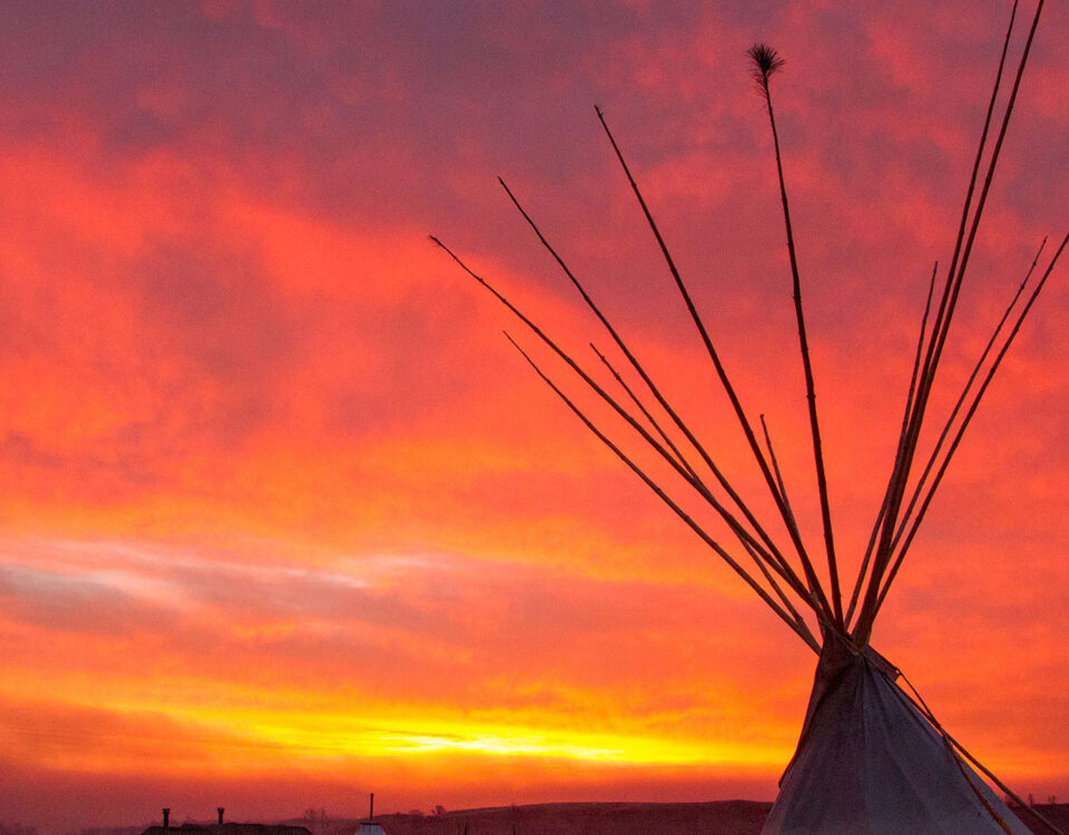 sunrise tipi with a red glow at Standing Rock Encampment Oceti Sakowin