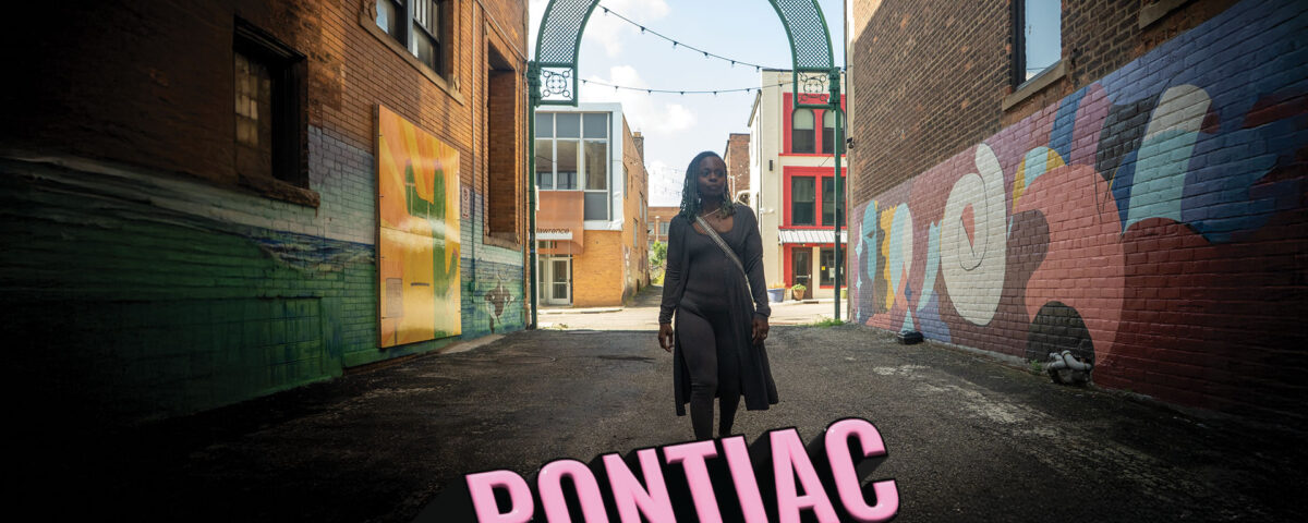 movie poster for the documentary film Pontiac - Roses Through The Thorns with Shaniqua Staples walking through a gritty alley with street art in Pontiac, Michigan