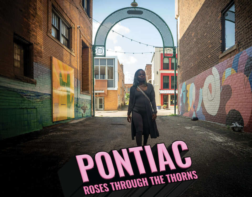 movie poster for the documentary film Pontiac - Roses Through The Thorns with Shaniqua Staples walking through a gritty alley with street art in Pontiac, Michigan
